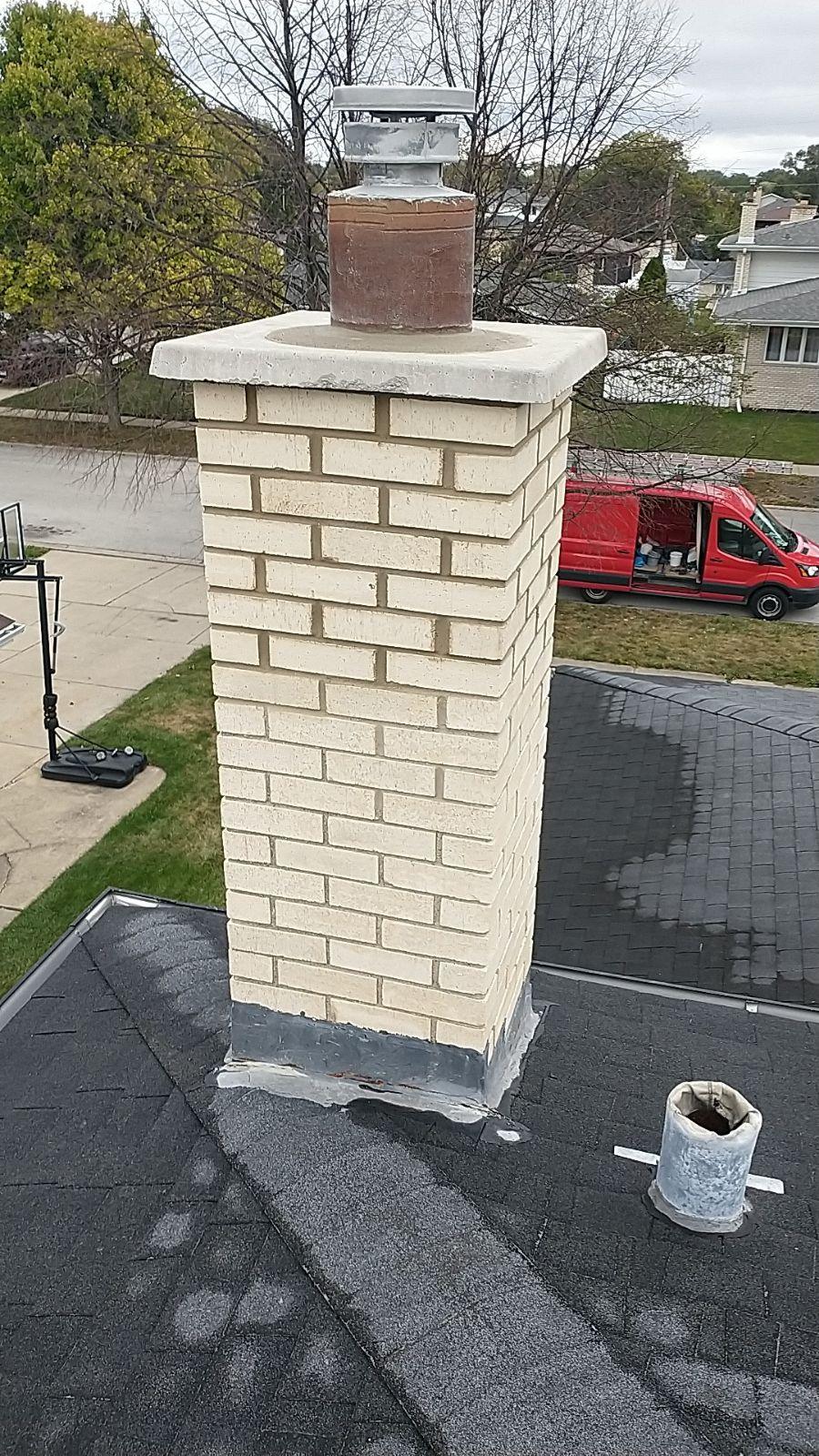 Chimney rebuild. Buff brick chimney rebuilt above the roofline.
