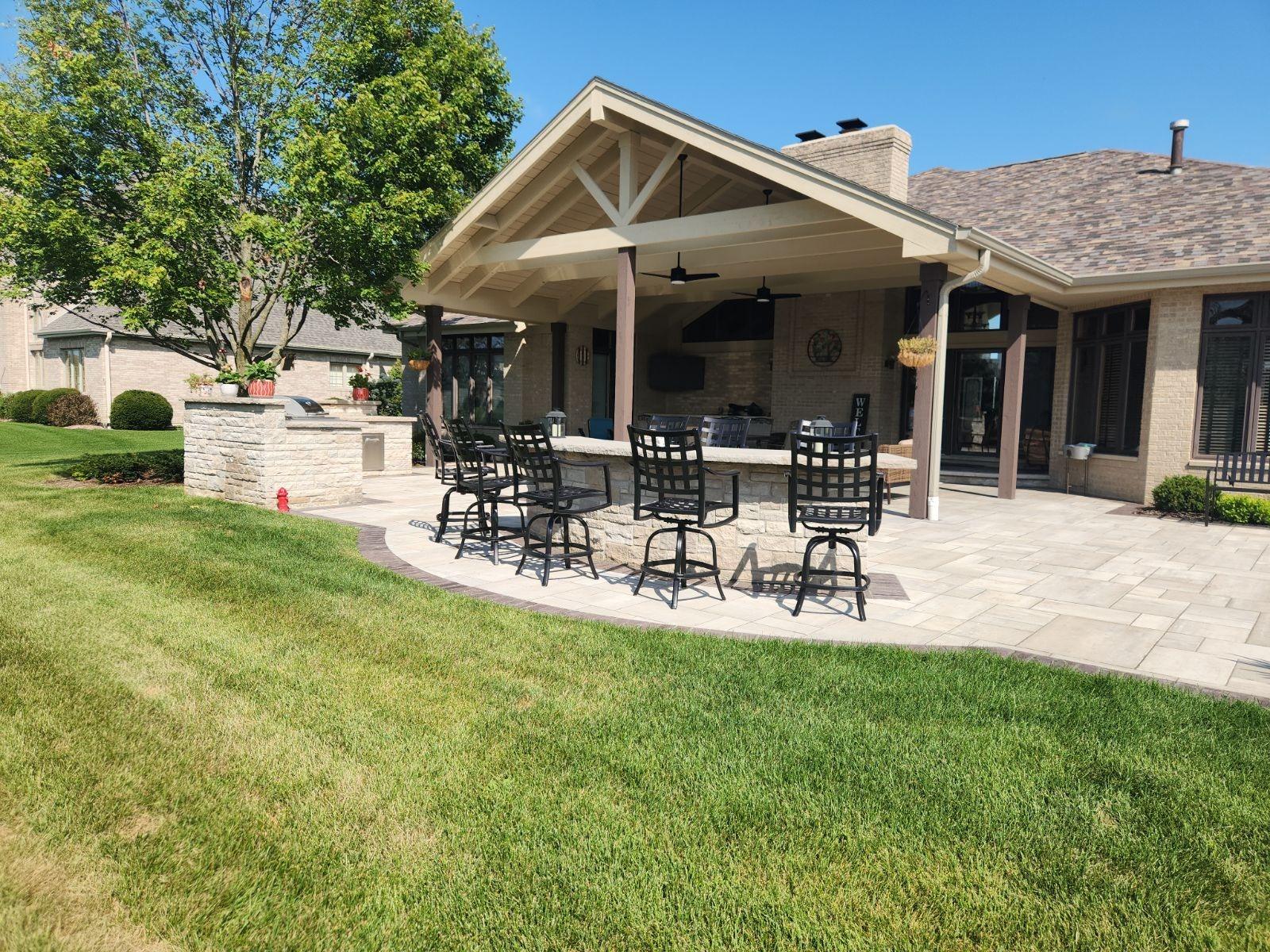 Covered patio. Stone outdoor kitchen and patio under a covered pavilion.