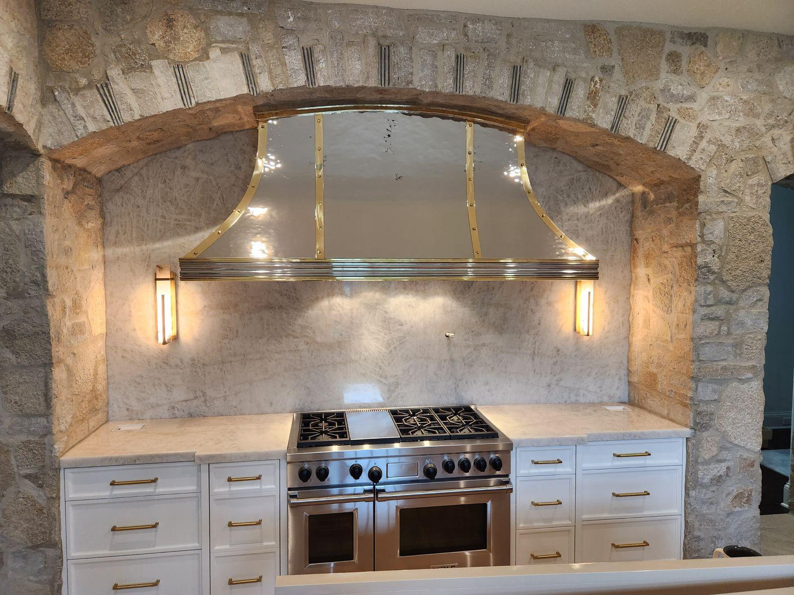Stone range hood arch. Interior stone arch built around a kitchen range hood.